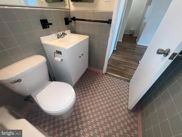 a white toilet sitting next to a bathroom sink