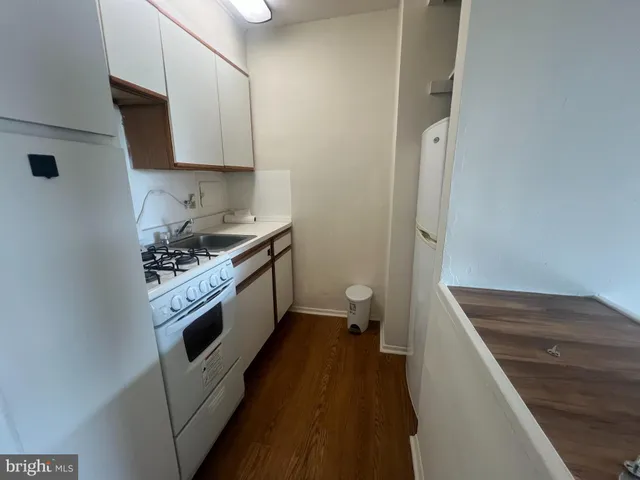 a kitchen with stainless steel appliances a white stove top oven and sink