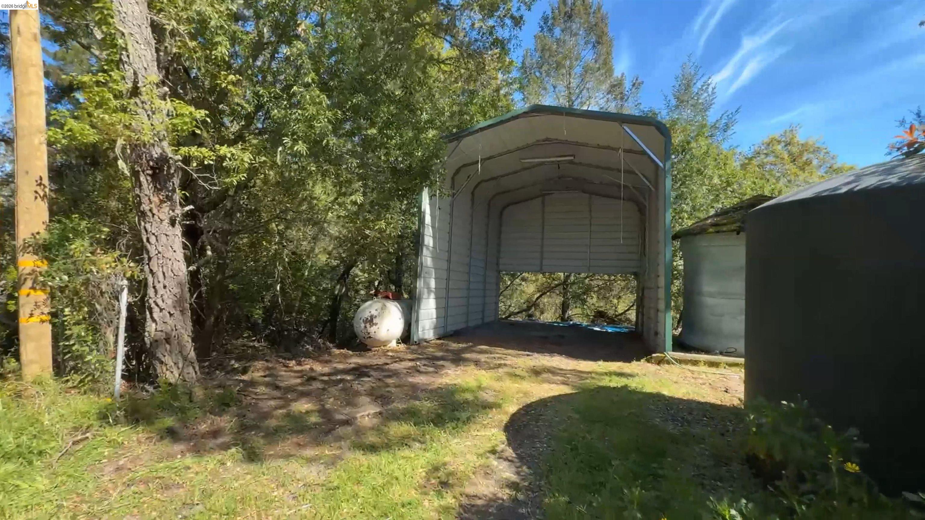 5051 Harrison Grade Road Sebastopol, CA 95472 - Photo 26 of 31 a view of a yard in front of a house with a large tree