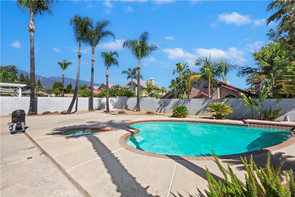7055 Mango Street Rancho Cucamonga, CA 91701 - Photo 28 of 32 a view of a swimming pool with a patio and a yard