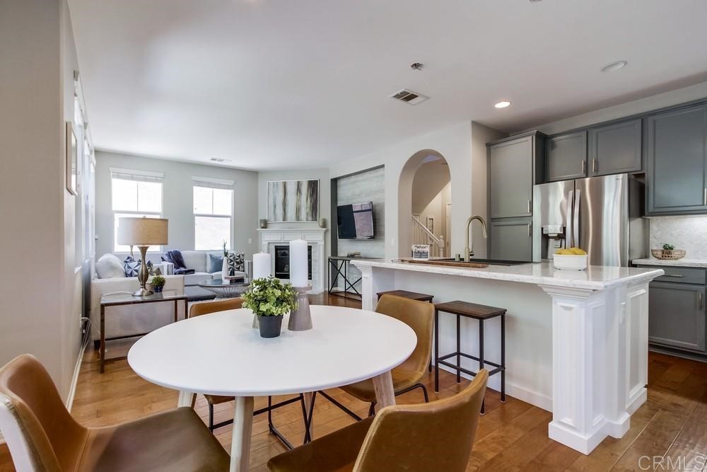 3400 Filoli Circle Carlsbad, CA 92009 - Photo 11 of 42 a view of a dining room with furniture and a chandelier