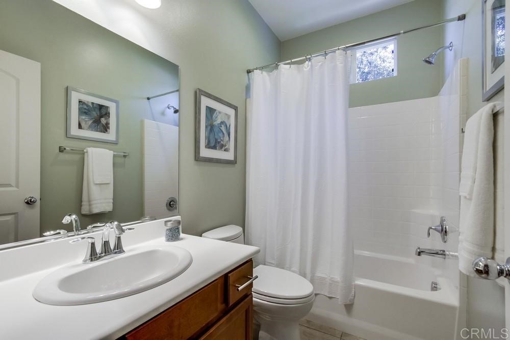 3400 Filoli Circle Carlsbad, CA 92009 - Photo 18 of 42 a bathroom with a sink toilet and shower