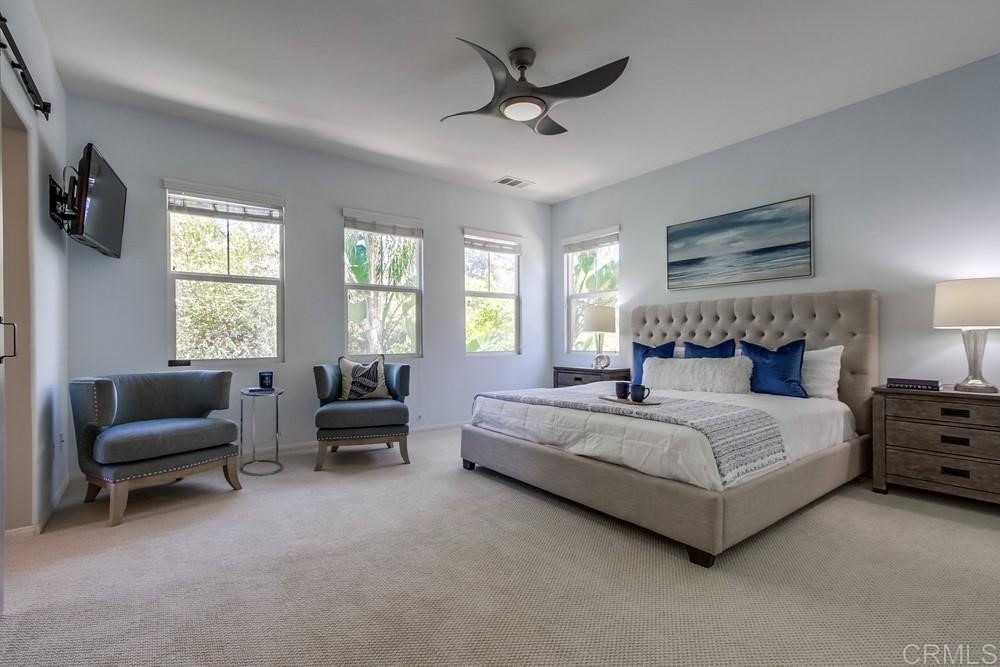 3400 Filoli Circle Carlsbad, CA 92009 - Photo 22 of 42 a spacious bedroom with a bed and a couch
