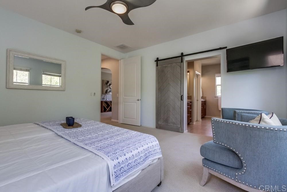 3400 Filoli Circle Carlsbad, CA 92009 - Photo 24 of 42 a bedroom with a bed and a flat screen tv