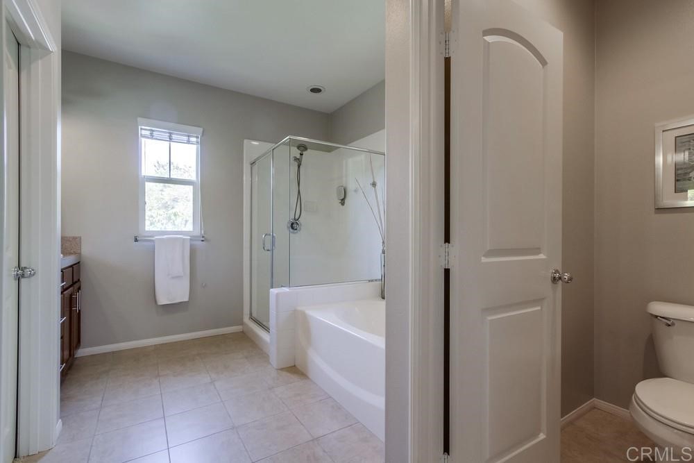 3400 Filoli Circle Carlsbad, CA 92009 - Photo 25 of 42 a bathroom with a bathtub sink and toilet