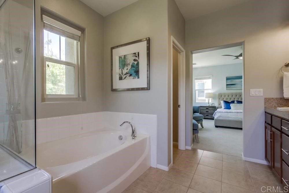 3400 Filoli Circle Carlsbad, CA 92009 - Photo 27 of 42 a en suite bathroom with a tub shower and couch