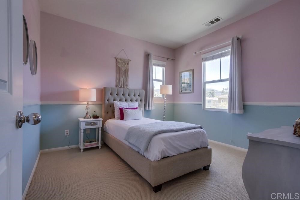 3400 Filoli Circle Carlsbad, CA 92009 - Photo 30 of 42 a bedroom with a bed and a potted plant