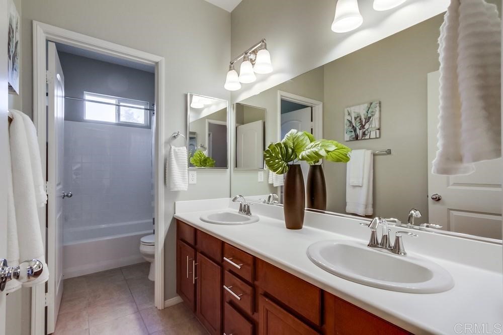 3400 Filoli Circle Carlsbad, CA 92009 - Photo 34 of 42 a bathroom with a sink double vanity and a mirror