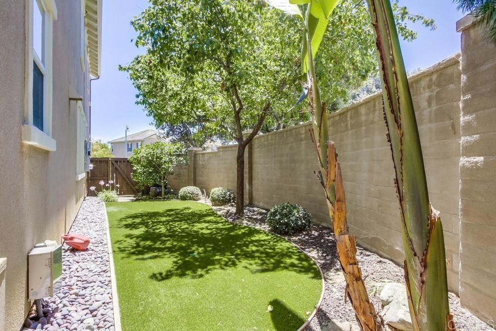 3400 Filoli Circle Carlsbad, CA 92009 - Photo 38 of 42 a backyard of a house with outdoor seating and plants