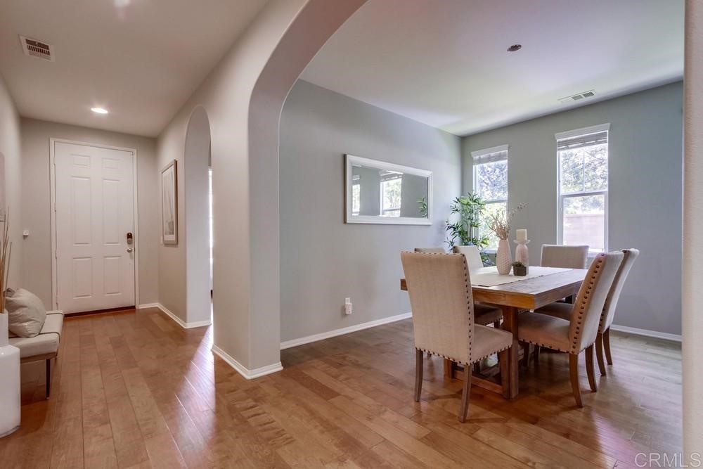 3400 Filoli Circle Carlsbad, CA 92009 - Photo 4 of 42 a view of a dining room with furniture and wooden floor