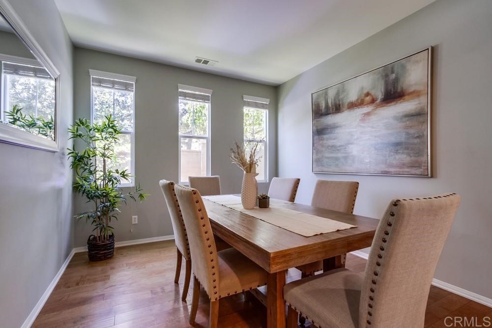 3400 Filoli Circle Carlsbad, CA 92009 - Photo 6 of 42 a view of a dining room with furniture window and wooden floor