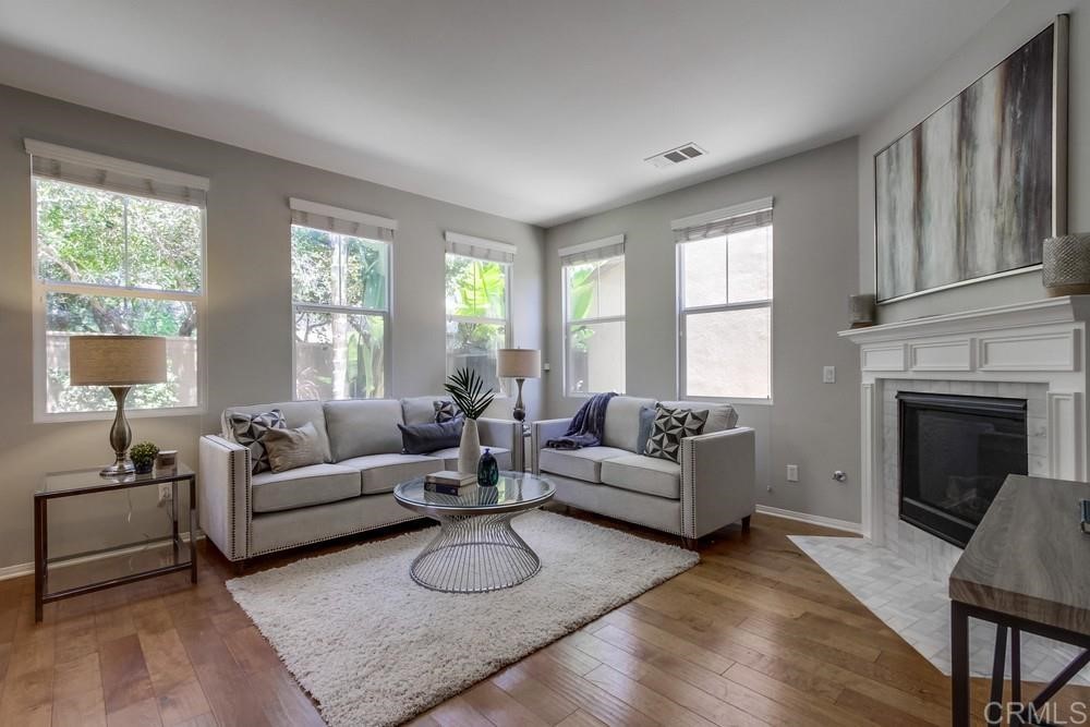 3400 Filoli Circle Carlsbad, CA 92009 - Photo 7 of 42 a living room with furniture a fireplace and a large window