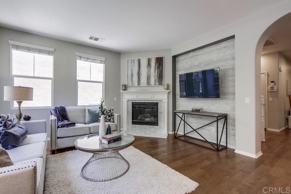 3400 Filoli Circle Carlsbad, CA 92009 - Photo 8 of 42 a living room with furniture a window and a fireplace