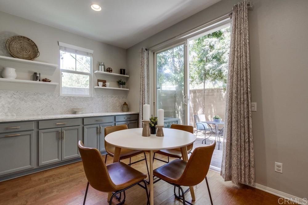 3400 Filoli Circle Carlsbad, CA 92009 - Photo 10 of 42 a kitchen with a dining table chairs and window