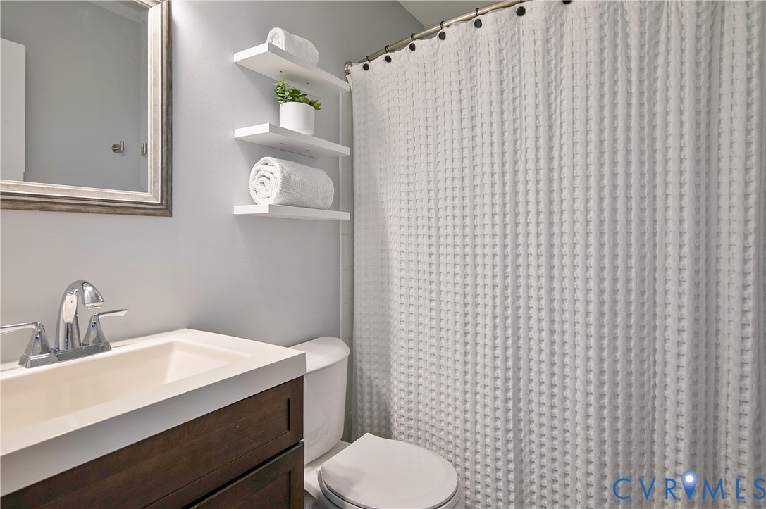 34 Brandywine Court Colonial Heights, VA 23834 - Photo 22 of 30 a bathroom with a sink a toilet and mirror