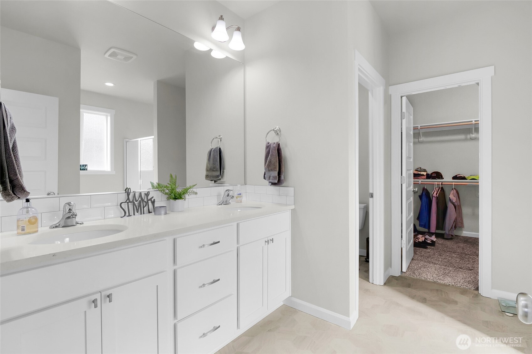 4705 West Merlin Street Moses Lake, WA 98837 - Photo 21 of 33 a spacious bathroom with a double vanity sink a mirror and a shower
