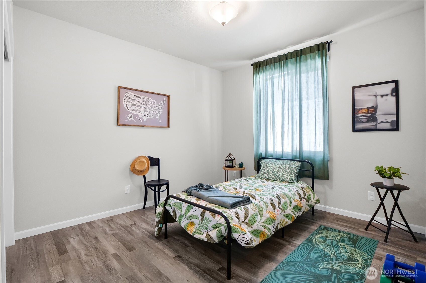 4705 West Merlin Street Moses Lake, WA 98837 - Photo 28 of 33 a bedroom with a bed and a potted plant