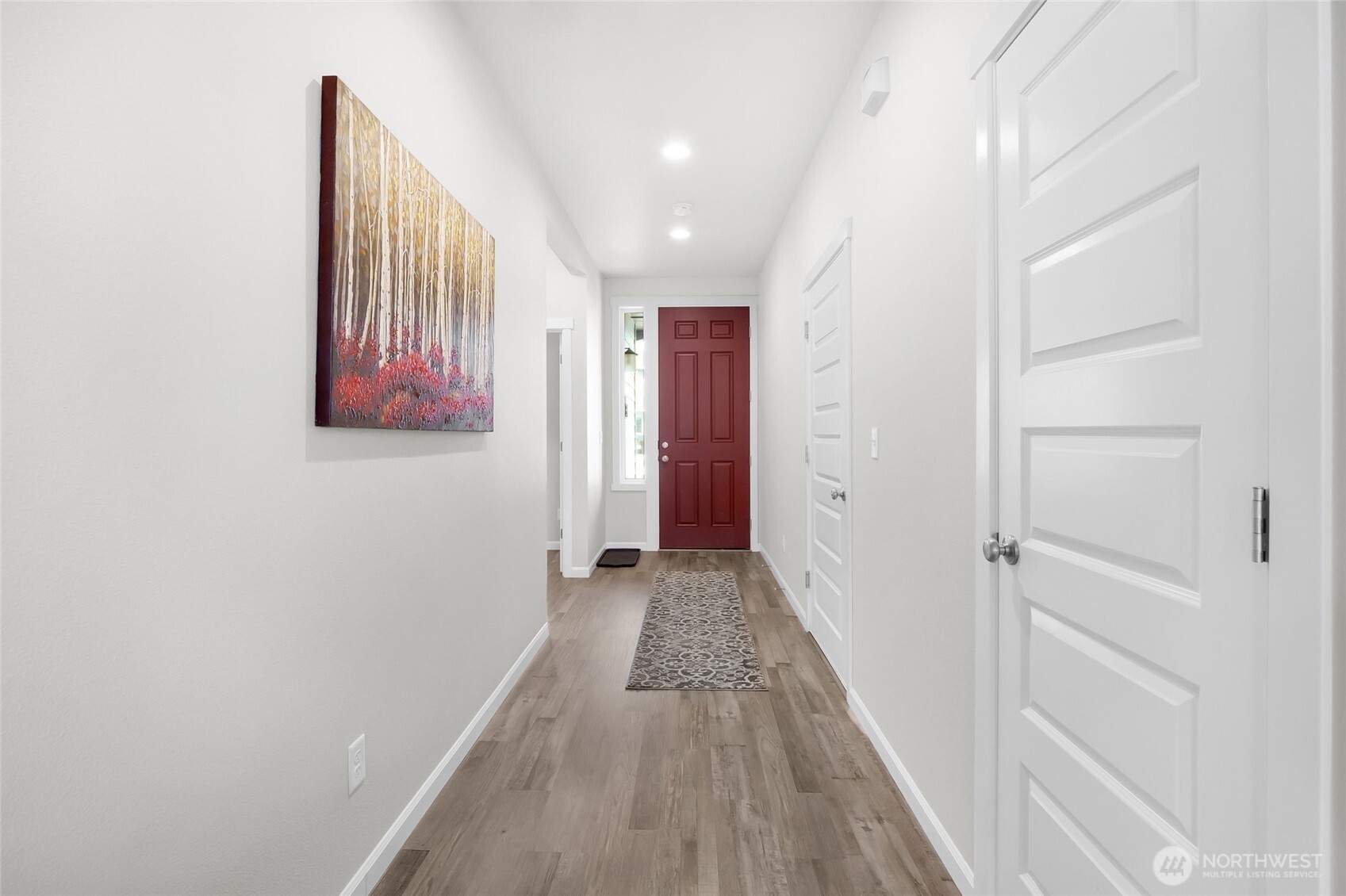4705 West Merlin Street Moses Lake, WA 98837 - Photo 9 of 33 a view of a hallway with wooden floor and closet