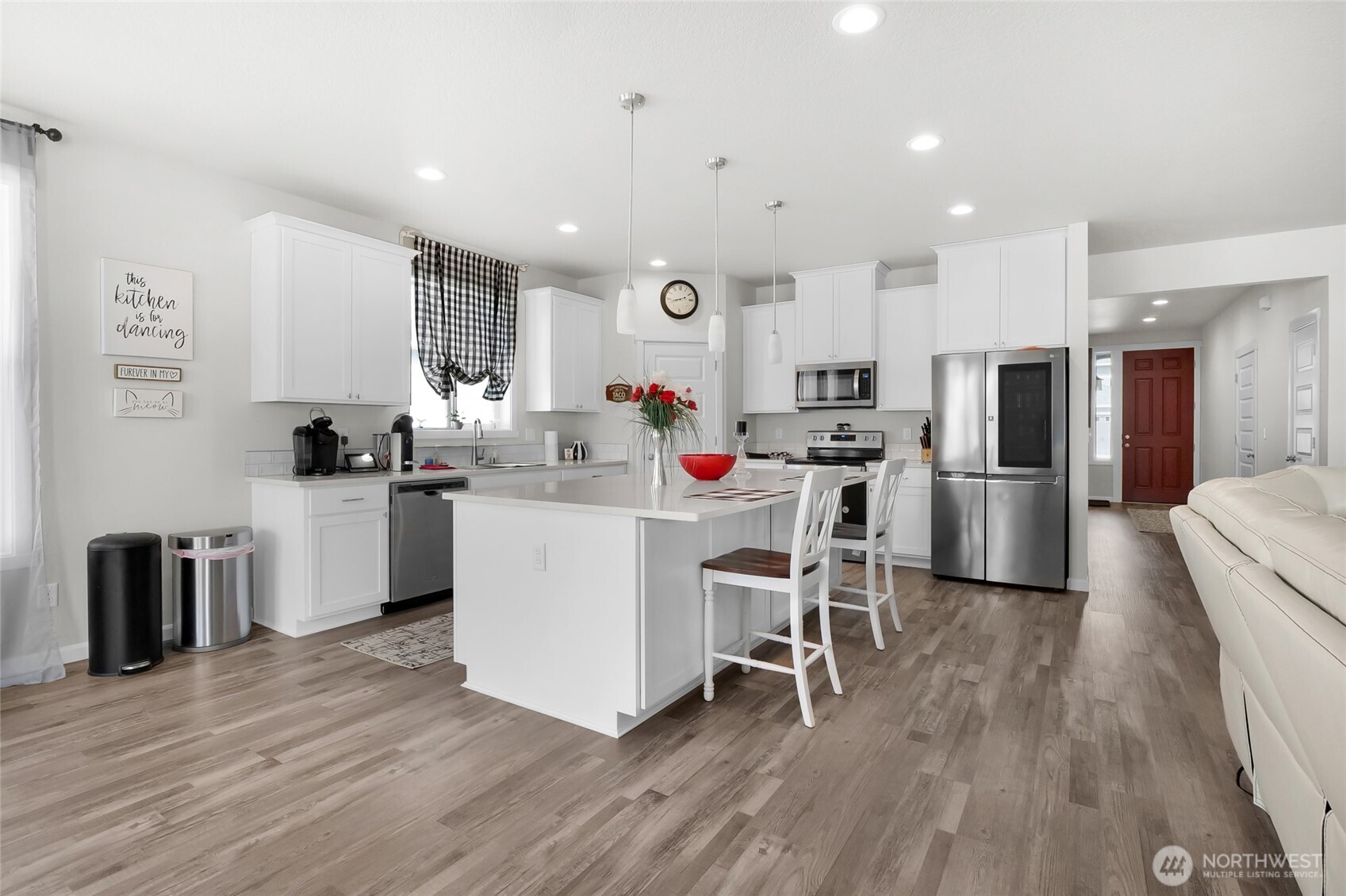 4705 West Merlin Street Moses Lake, WA 98837 - Photo 10 of 33 a kitchen with white cabinets and stainless steel appliances