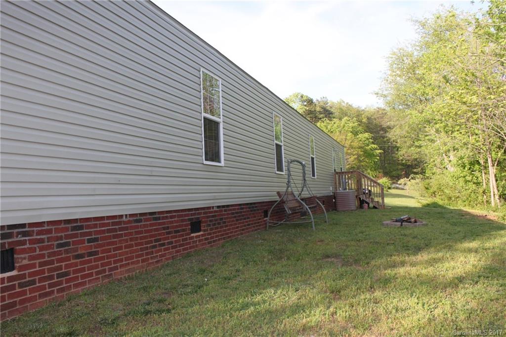 421 Cleghorn Mill Road, Unit 30 Rutherfordton, NC 28139 - Photo 21 of 23 a backyard of a house with table and chairs