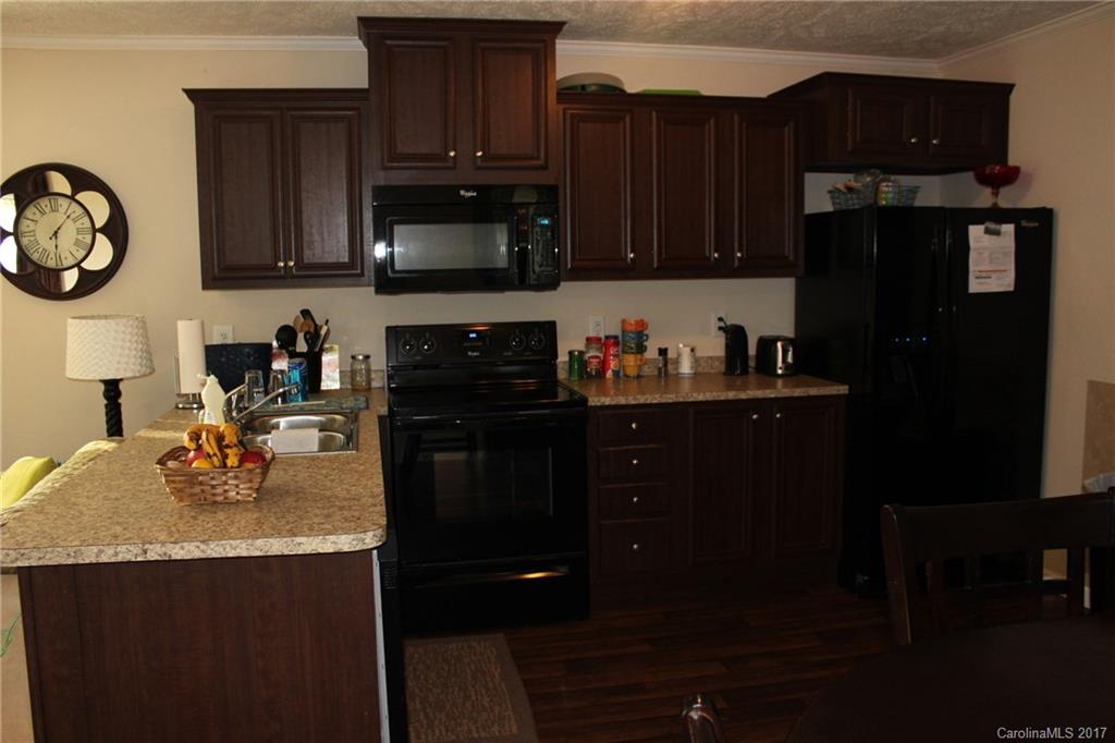 421 Cleghorn Mill Road, Unit 30 Rutherfordton, NC 28139 - Photo 3 of 23 a kitchen with a sink and cabinets
