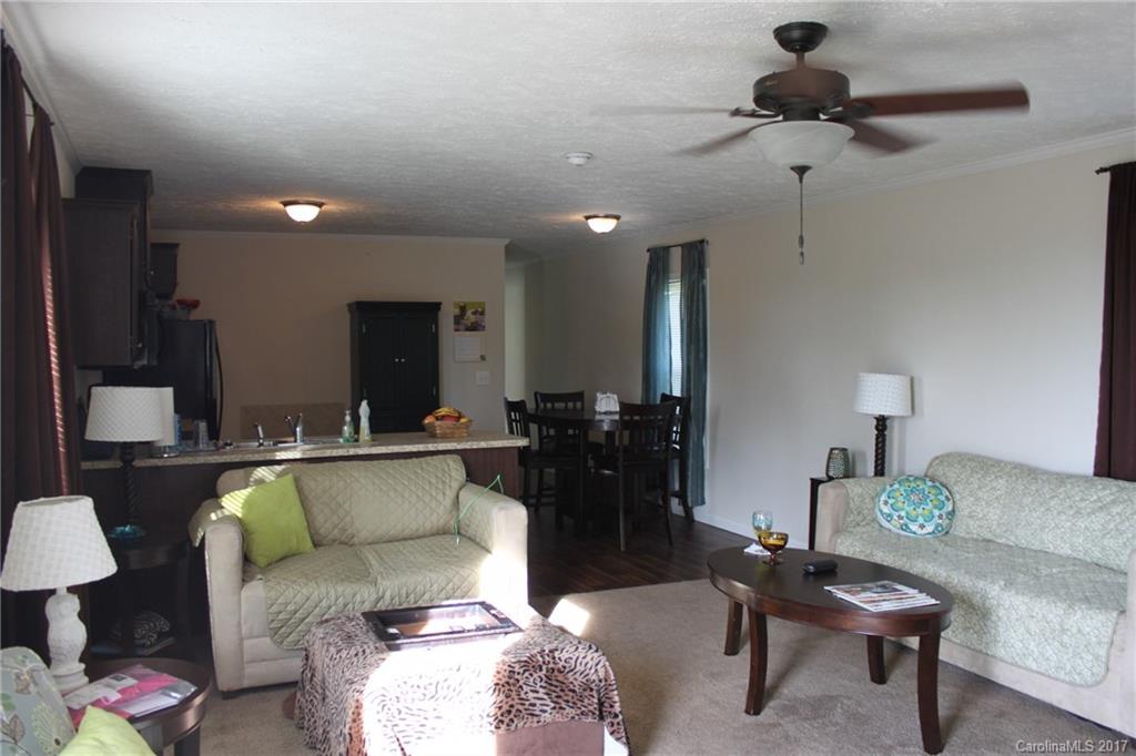 421 Cleghorn Mill Road, Unit 30 Rutherfordton, NC 28139 - Photo 7 of 23 a living room with furniture and a chandelier