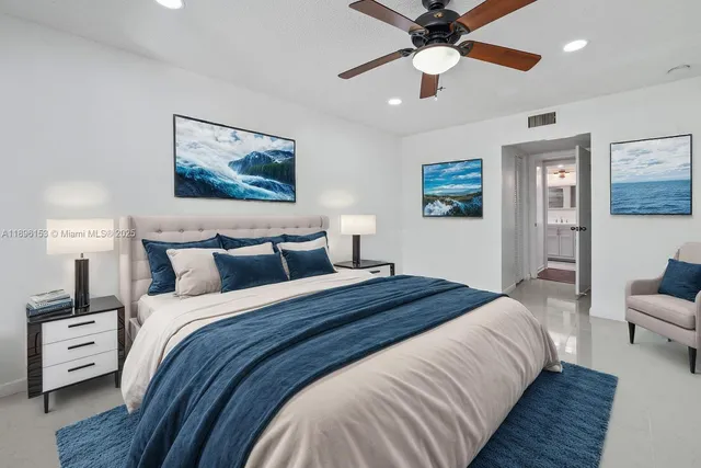 a bedroom with bed and a chandelier