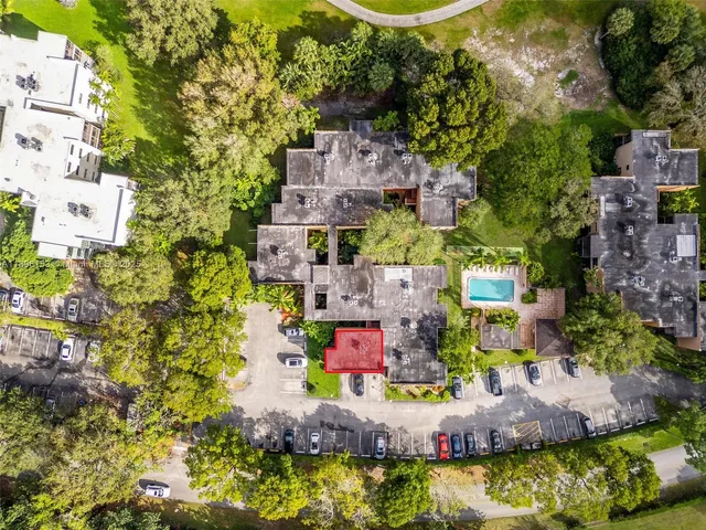 an aerial view of residential houses with outdoor space and swimming pool