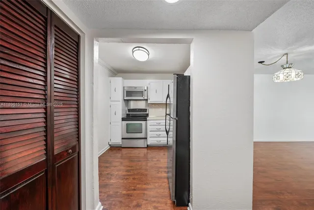 a view of a kitchen with wooden floor