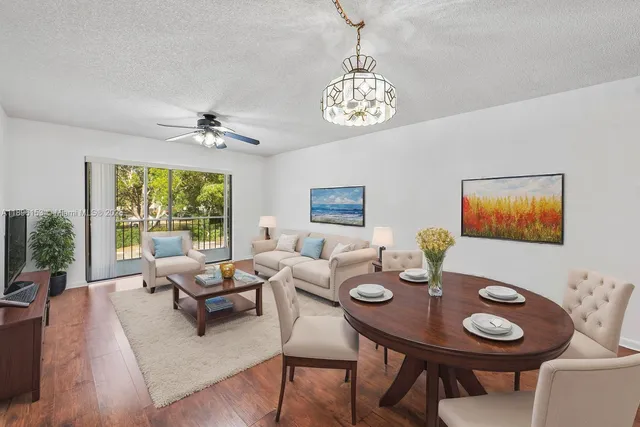 a view of a dining room with furniture wooden floor and chandelier