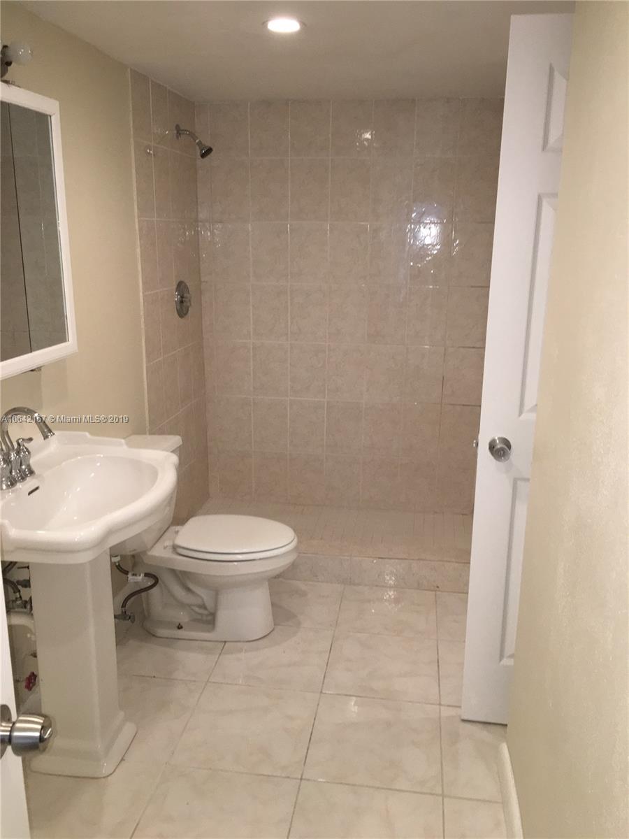 4164 Inverrary Drive, Unit 813 Lauderhill, FL 33319 - Photo 12 of 25 a bathroom with a toilet a sink and a mirror