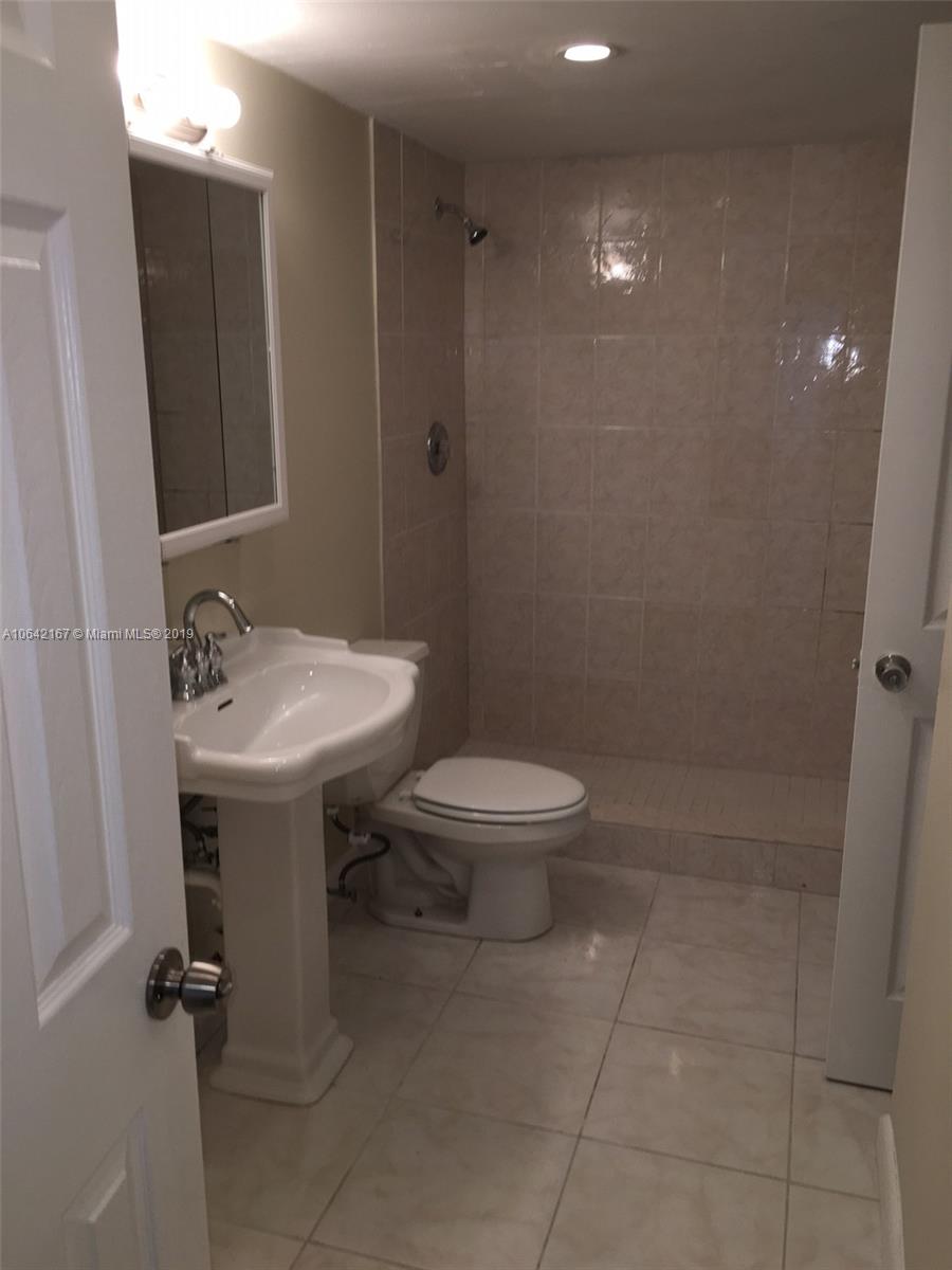 4164 Inverrary Drive, Unit 813 Lauderhill, FL 33319 - Photo 13 of 25 a bathroom with a sink toilet and shower