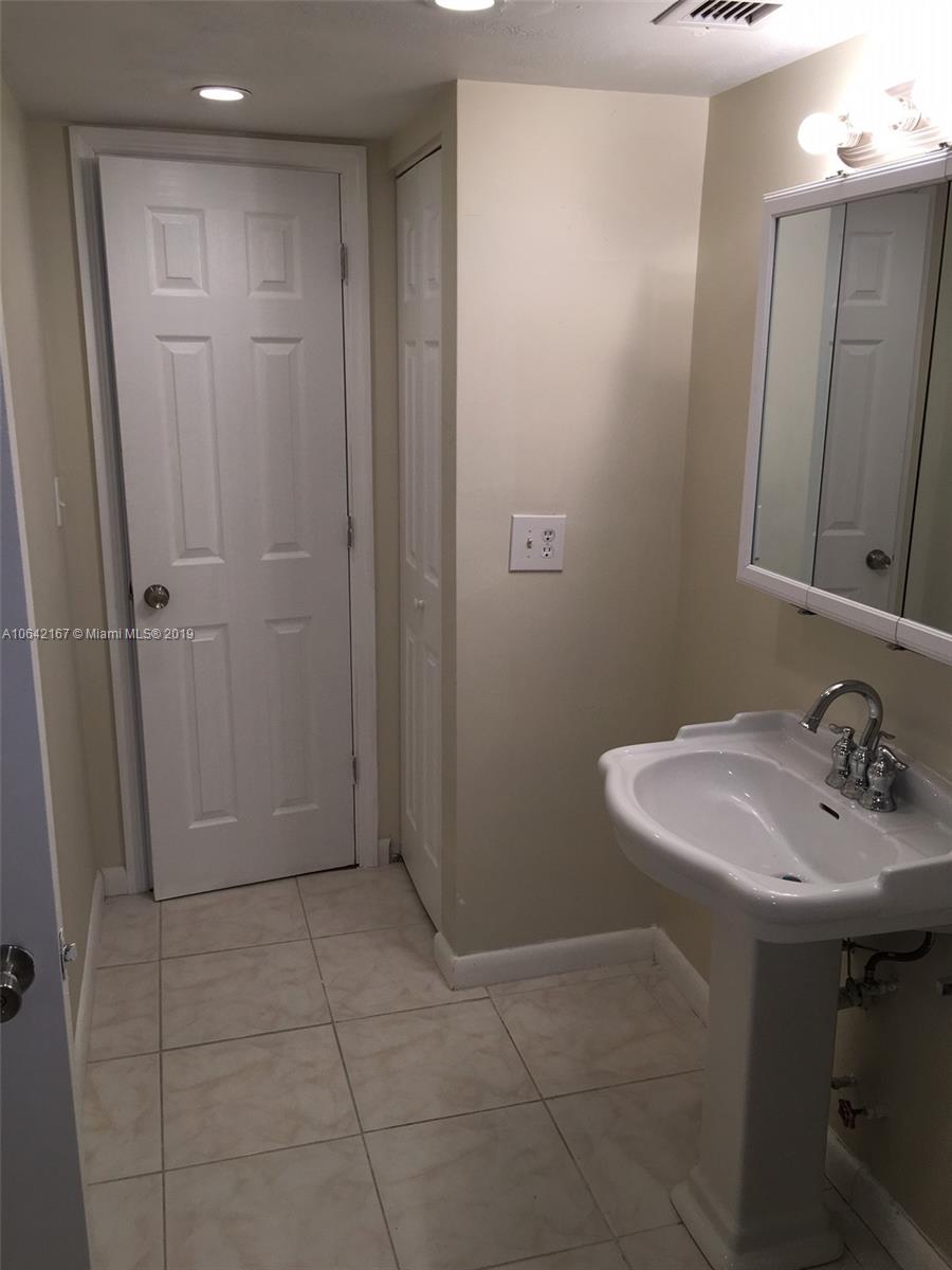 4164 Inverrary Drive, Unit 813 Lauderhill, FL 33319 - Photo 14 of 25 a bathroom with a sink a toilet and a mirror