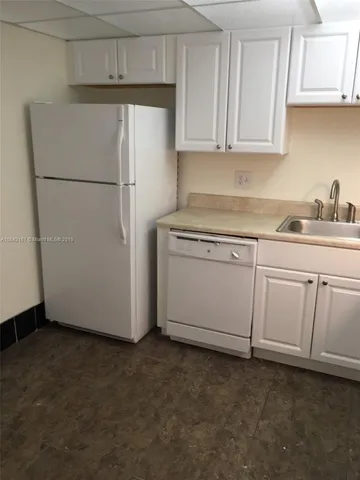 a white refrigerator freezer sitting in a kitchen