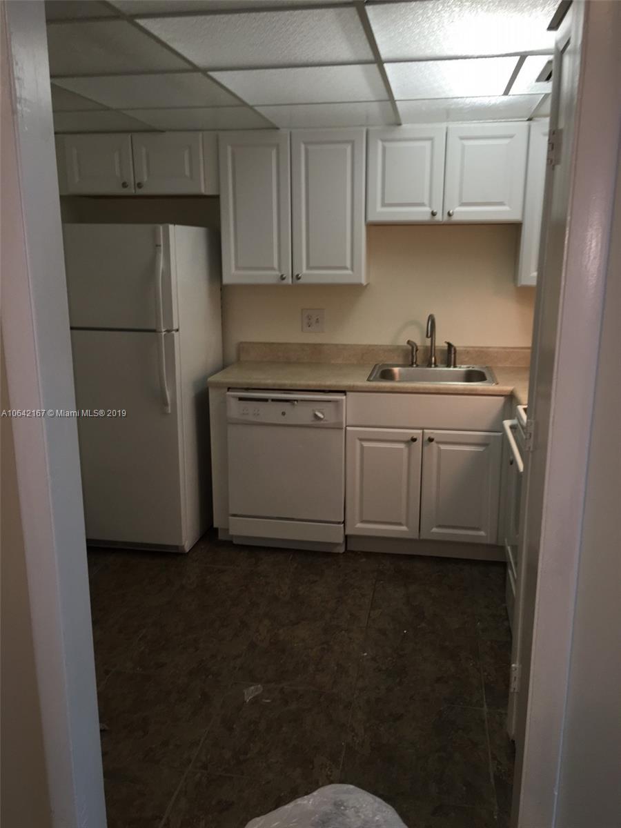 4164 Inverrary Drive, Unit 813 Lauderhill, FL 33319 - Photo 17 of 25 a kitchen with a sink and cabinets