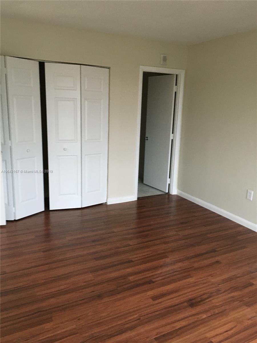4164 Inverrary Drive, Unit 813 Lauderhill, FL 33319 - Photo 7 of 25 a view of an empty room with wooden floor and entrance