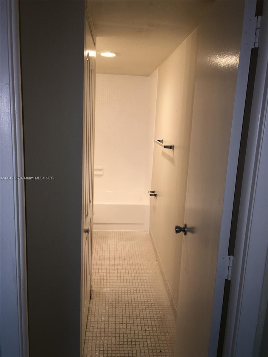 4164 Inverrary Drive, Unit 813 Lauderhill, FL 33319 - Photo 9 of 25 a bathroom with a shower and a glass door