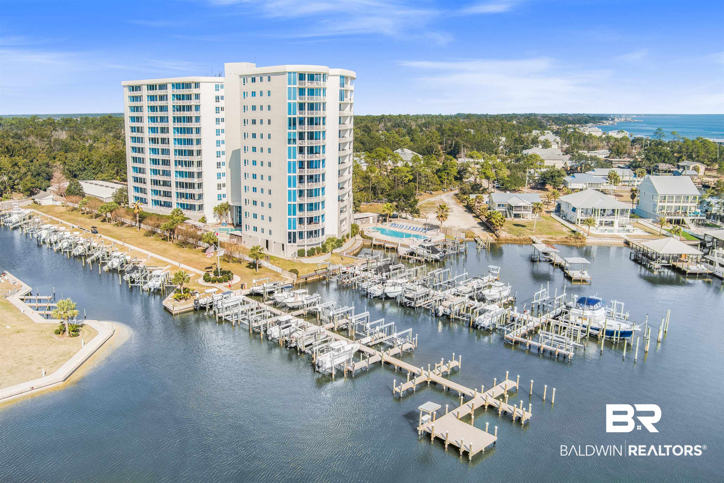 28250 Canal Road, Unit 106 Orange Beach, AL 36561 - Photo 41 of 50 Bird's eye view of a large body of water and numerous boat docks