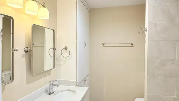a bathroom with a granite countertop shower and a sink
