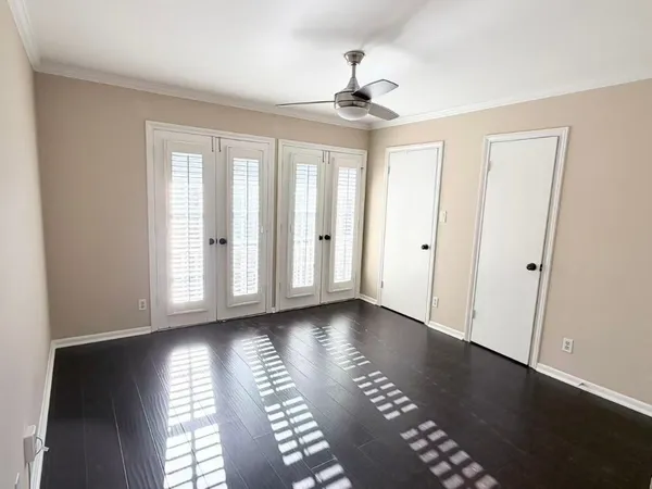 a view of an empty room with glass door and a window
