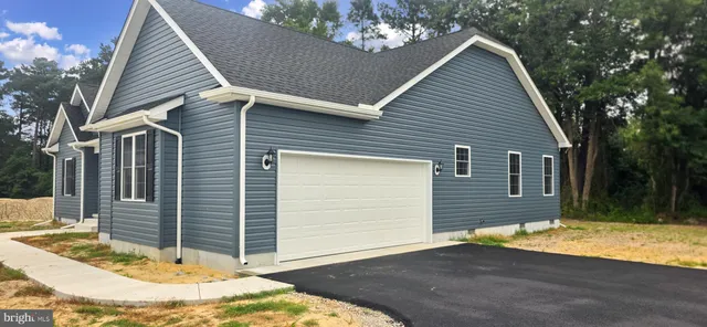 a view of house with backyard