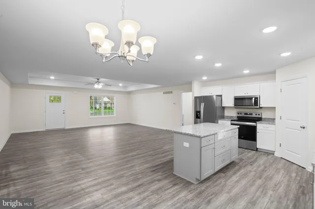 a view of kitchen with cabinets and wooden floor