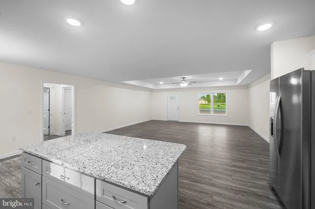 an empty room with wooden floor and window