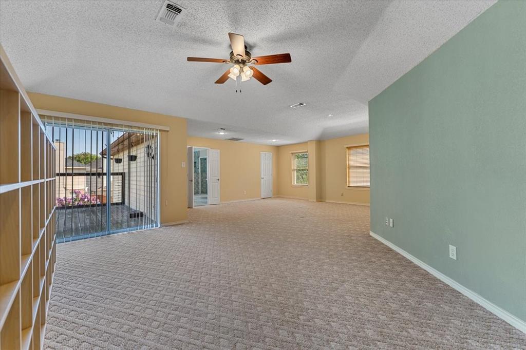 6752 MacIntosh Drive Plano, TX 75023 - Photo 15 of 40 Carpeted spare room featuring a textured ceiling and ceiling fan
