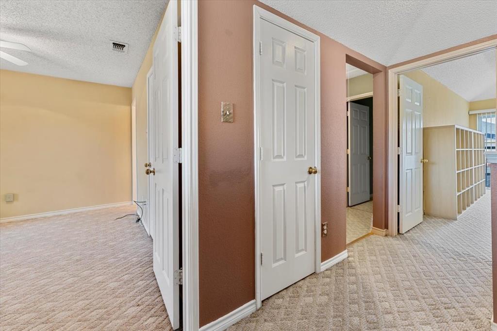 6752 MacIntosh Drive Plano, TX 75023 - Photo 28 of 40 Corridor with a textured ceiling and light carpet