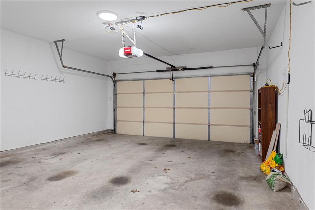 6752 MacIntosh Drive Plano, TX 75023 - Photo 36 of 40 Garage featuring a garage door opener