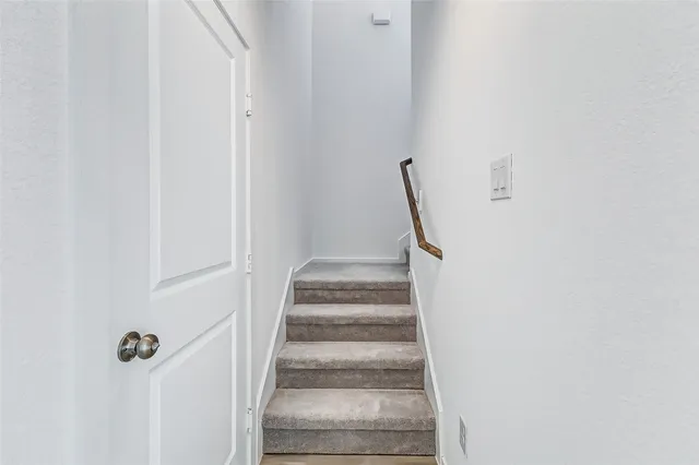 a view of staircase with white walls