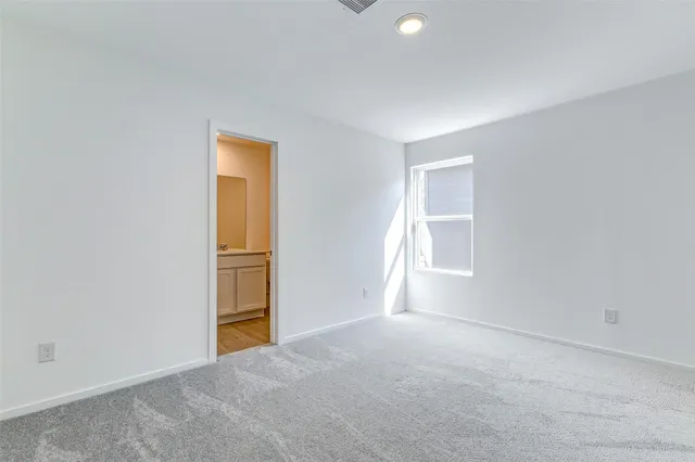 a bathroom with a toilet a sink a mirror and vanity