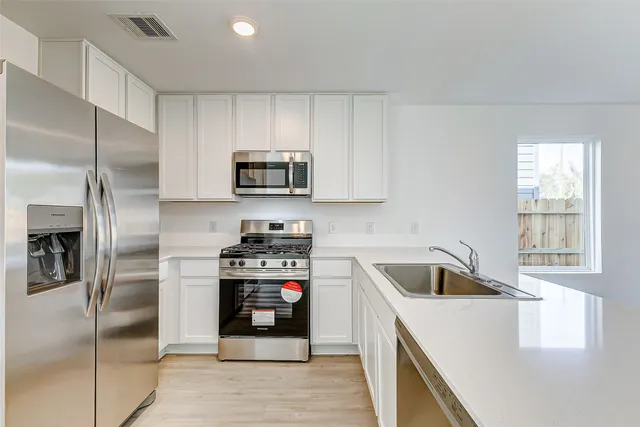 a kitchen with a refrigerator sink and microwave