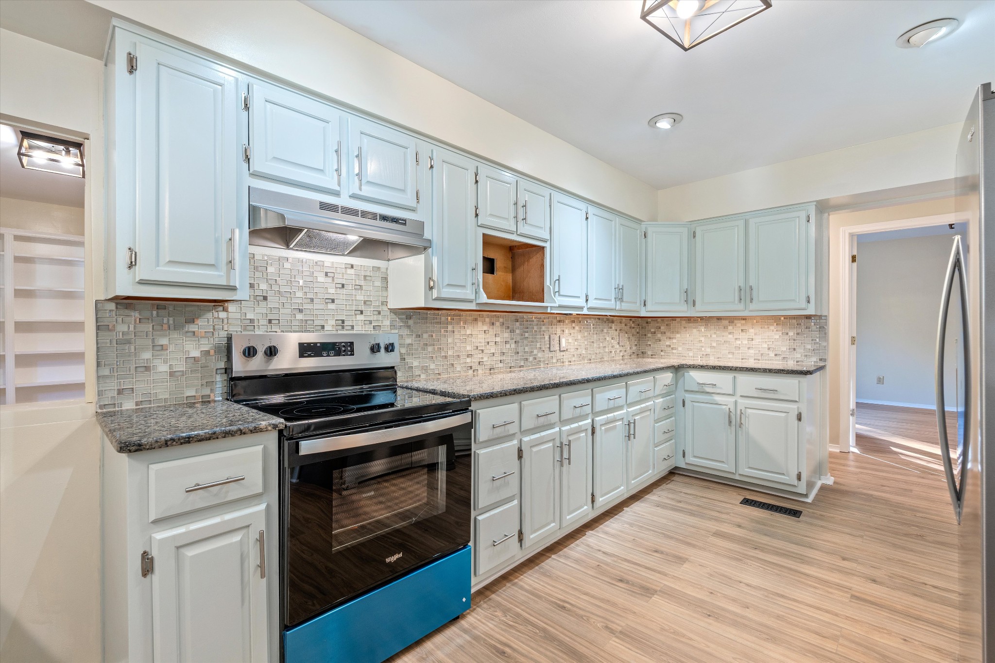 31 Volunteer Circle Carthage, TN 37030 - Photo 15 of 52 a kitchen with granite countertop wooden cabinets stainless steel appliances and a wooden floor